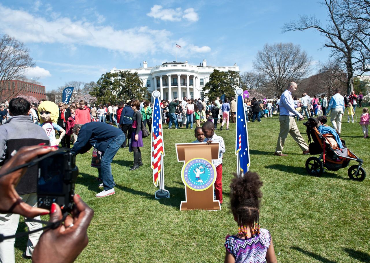 Children have their picture taken at a mock presidential podium.