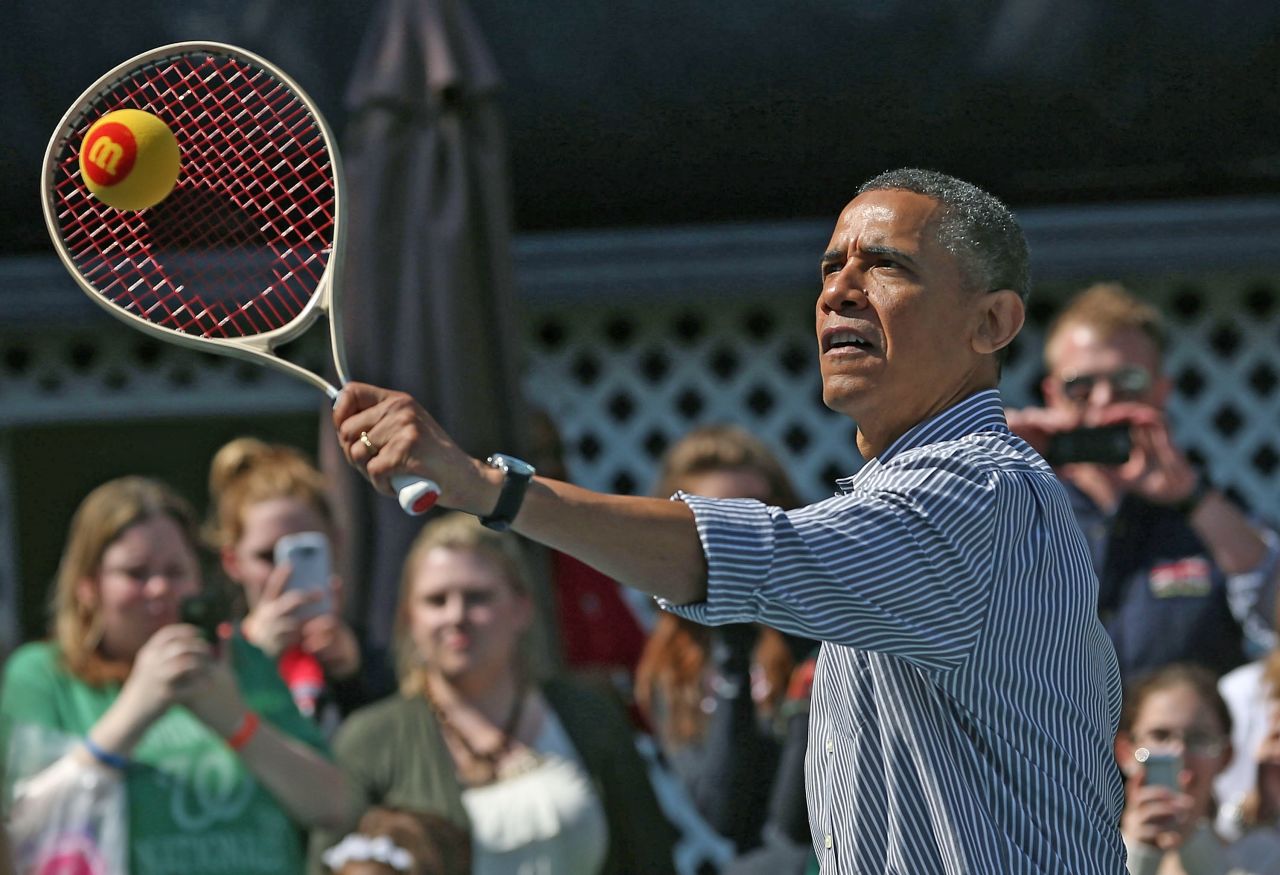 Obama plays tennis with children.