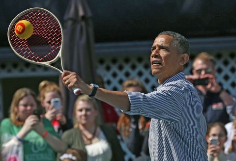 Obama plays tennis with children.
