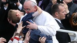 VATICAN CITY, VATICAN - MARCH 31: Pope Francis embraces a boy prior to his first 'Urbi et Orbi' blessing from the balcony of St. Peter's Basilica during Easter Mass on March 31, 2013 in Vatican City, Vatican. Pope Francis delivered his message to the gathered faithful from the central balcony of St. Peter's Basilica in St. Peter's Square after his first Holy week as Pontiff. (Photo by Franco Origlia/Getty Images)