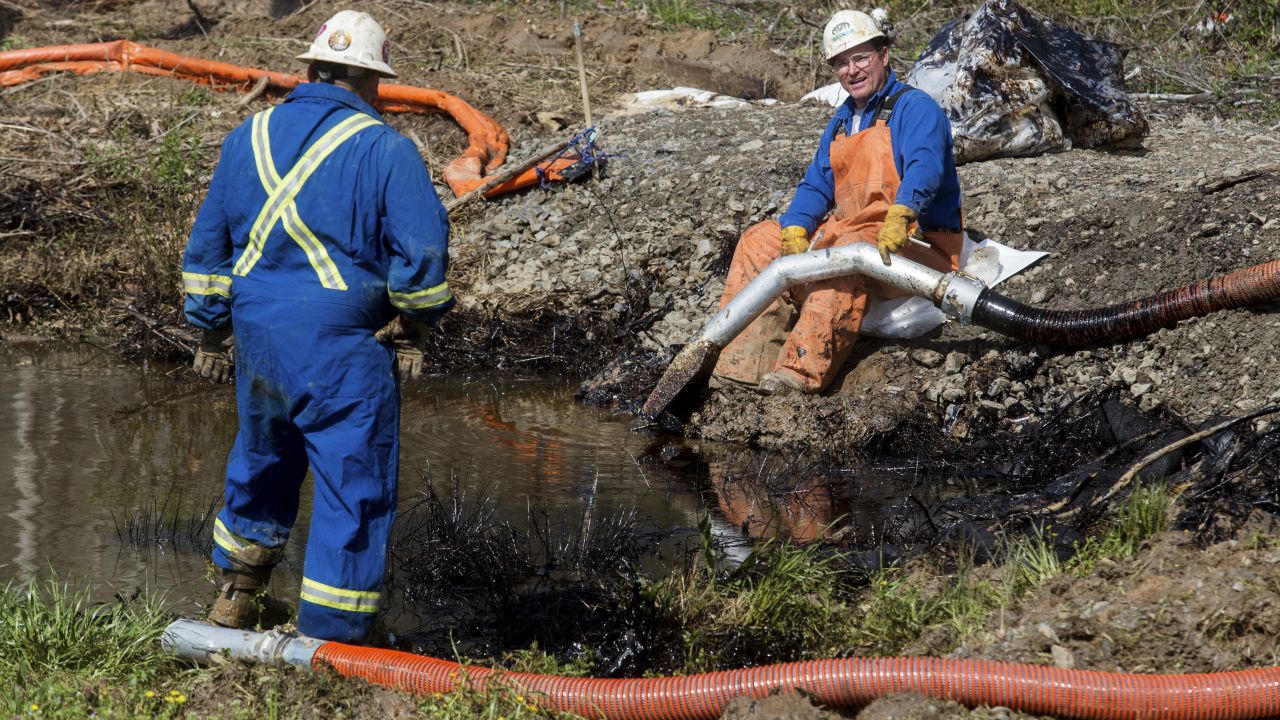 Emergency crews clean up more of the spill in Mayflower.