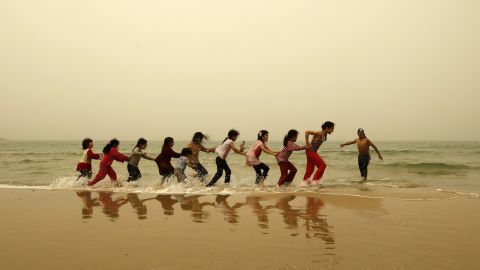 Children play on the beach in Gaza City during a dust storm on Monday, April 1.