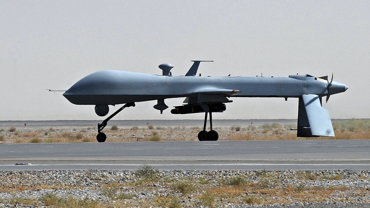 A U.S. Predator unmanned drone armed with a missile on the tarmac at Kandahar military airport in June 2010. 