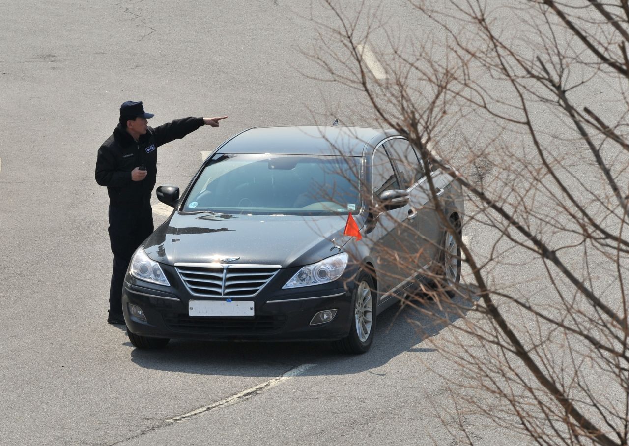 An officer directs a South Korean car that was denied access at a military checkpoint in Paju.
