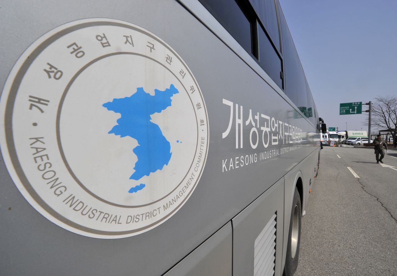 A South Korean soldier walks past a Kaesong Industrial District Management Committee bus at the Inter-Korean Transit Office in April.