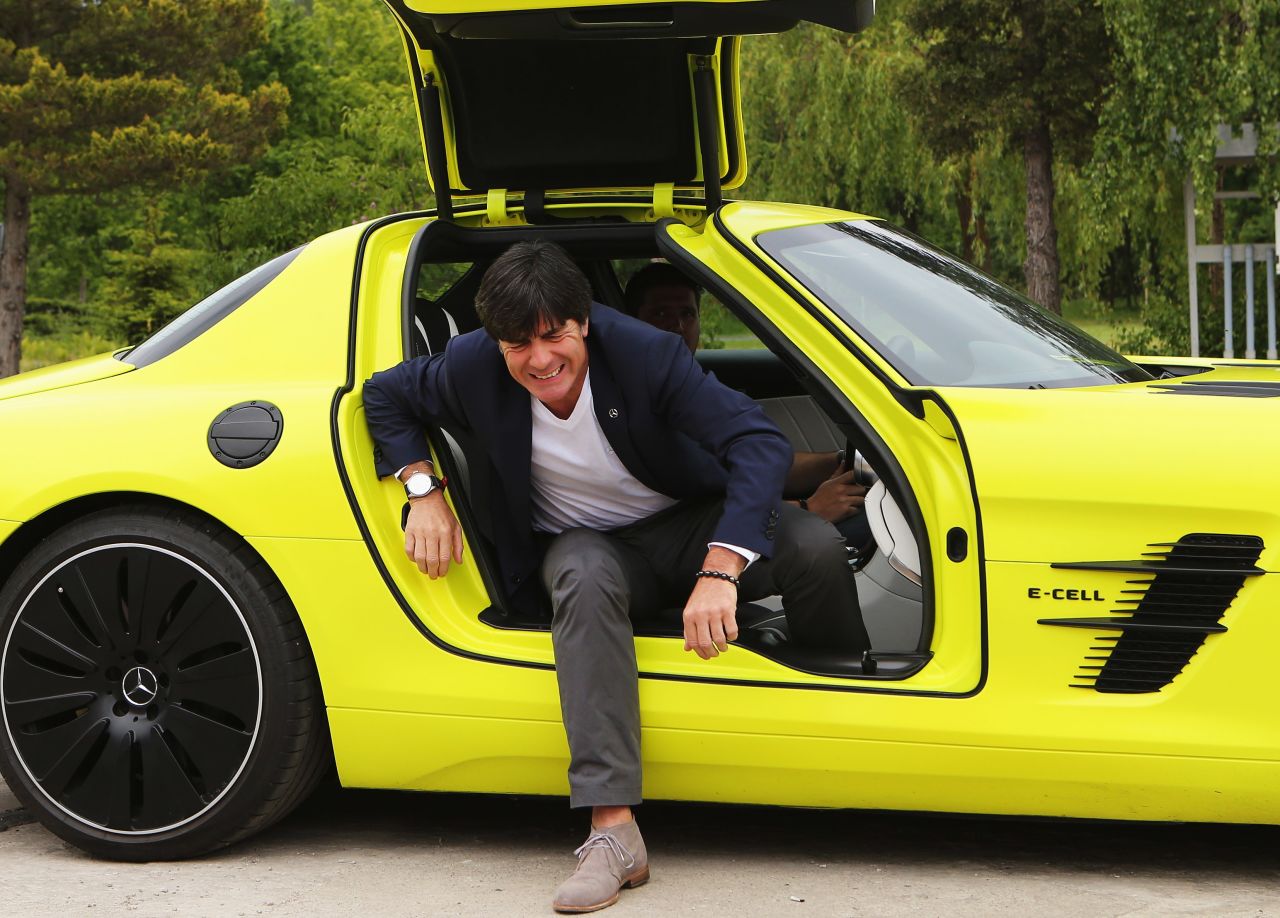 Germany coach Joachim Loew gets out of a Mercedes SLS AMG E-Cell in another sponsorship event.