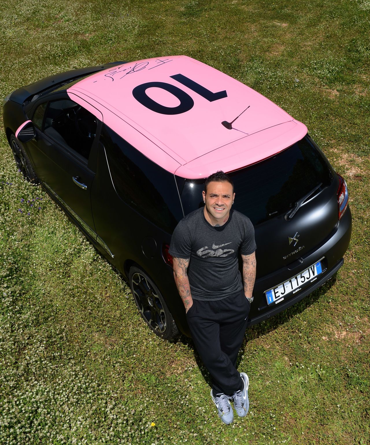 Former Palermo striker Fabrizio Miccoli poses near the Citroen DS3 which was designed for charity.