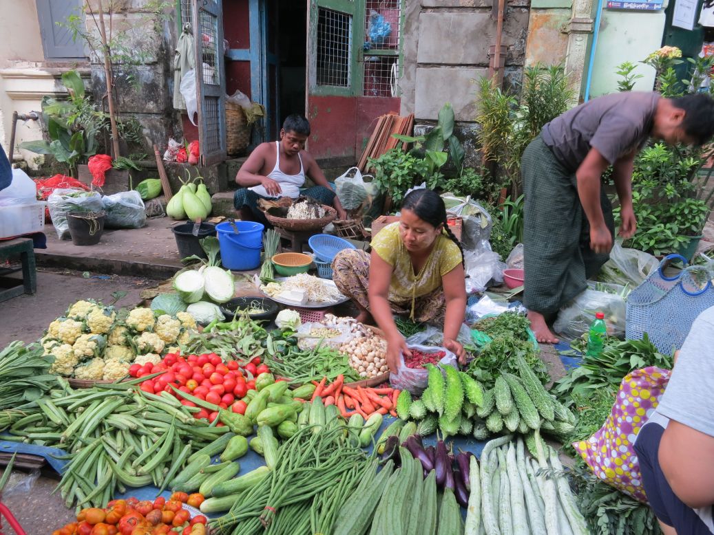 Vendors hawk vibrant produce at open-air markets.