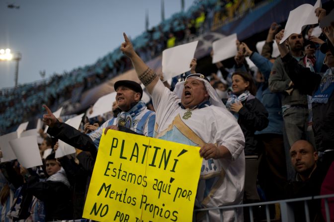 Malaga fans protest against UEFA president Michel Platini over threats to refuse the club permission to play in European competition next season because of its financial situation. 