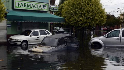 Partially submerged cars are seen outside a pharmacy in La Plata on April 3.