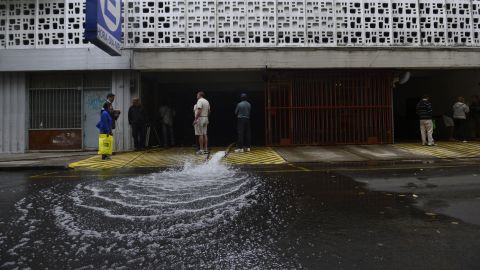 Workers pump water out of a flooded parking garage on April 3 in the Nunez neighborhood of Buenos Aires.