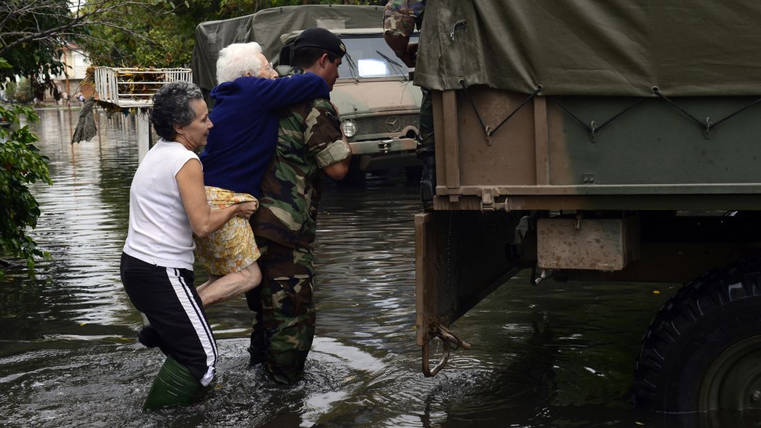 A soldier carries an elderly woman as residents evacuate La Plata on April 3.