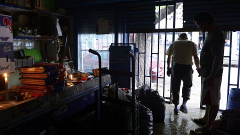 A worker walks out of a supermarket that was flooded and lost power on April 3 in the neighborhood of Belgrano in Buenos Aires.