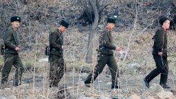 North Korean soldiers patrol along the bank of the Yalu River in the North Korean town of Sinuiju across from the Chinese city of Dandong on April 4, 2013. 