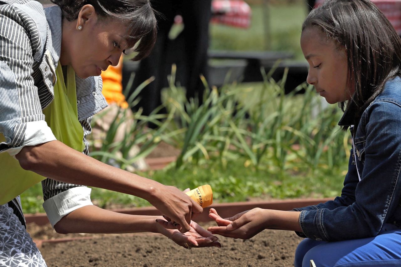 Obama shares a packet of seeds with Ariana Docanto of Somerville, Massachusetts.