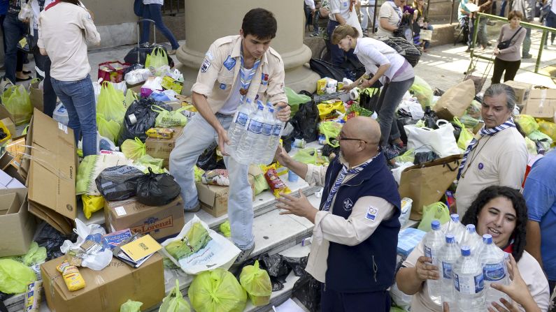 Volunteers load donated supplies in front of the Metropolitan Cathedral in Buenos Aires on Thursday, April 4. A storm has claimed dozens of lives in the capital and nearby La Plata, officials said.