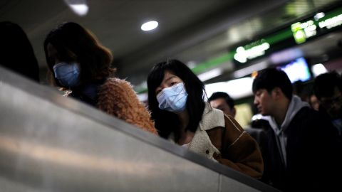 A woman wears a face mask inside a subway station in Shanghai, China, on Friday, April 5. The Chinese minister of agriculture said Thursday it had discovered the H7N9 virus in samples taken from pigeons at Huhai agricultural market, China's state-run Xinhua news agency reported.