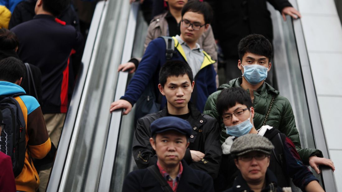 Men wear face masks at a shopping mall in downtown Shanghai on April 5.