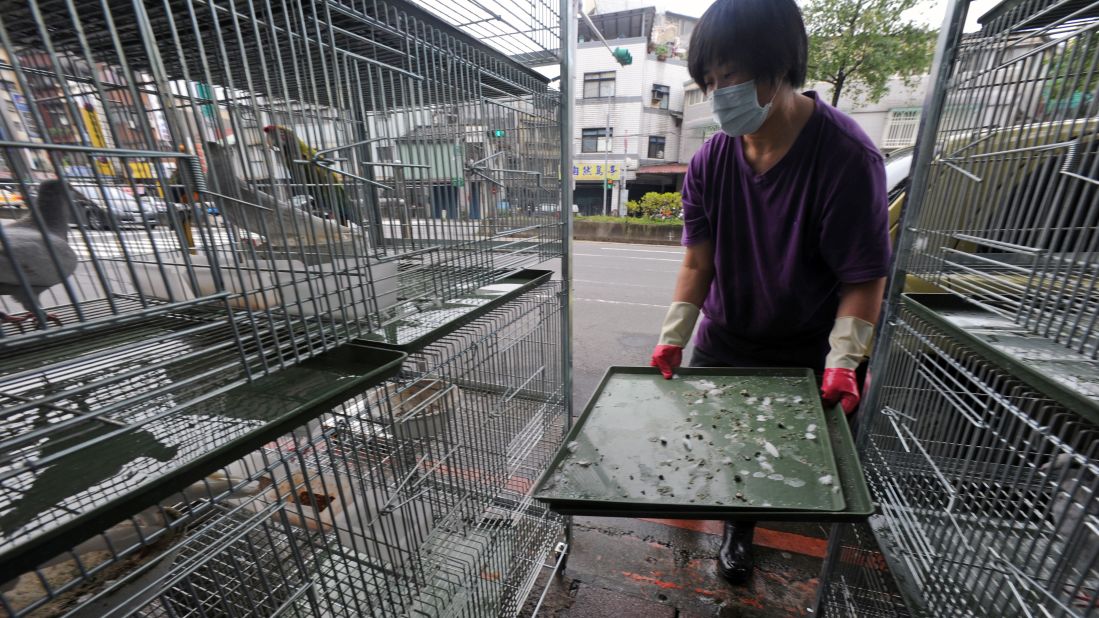 A woman cleans a birdcage at a store in Taipei, Taiwan, on Thursday, April 4.