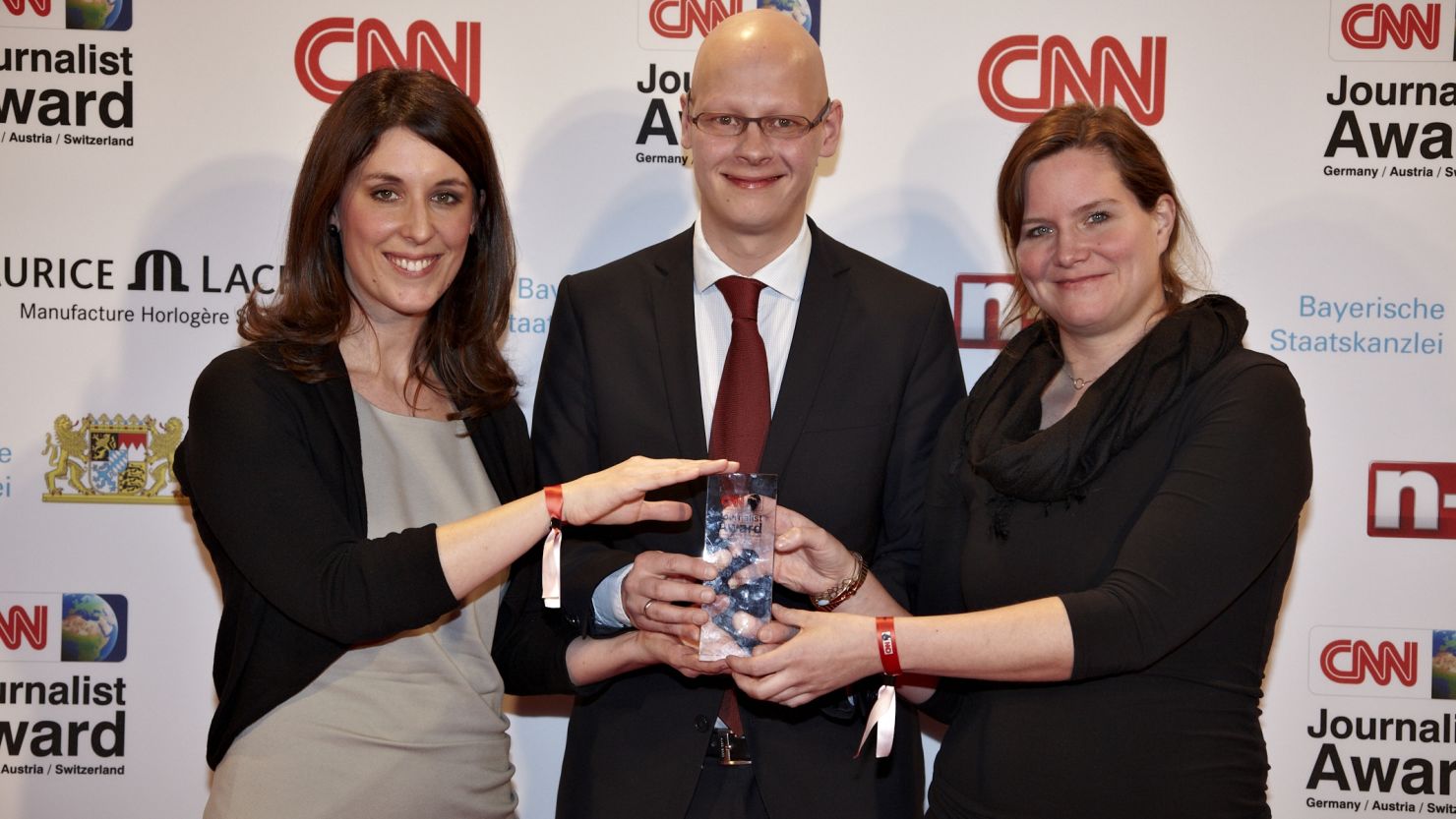 (L-R)  Anne-Kathrin Thuringer, Matthias Deiss and Eva Muller pose with their award after scooping both the TV category and CNN Journalists of the Year. 