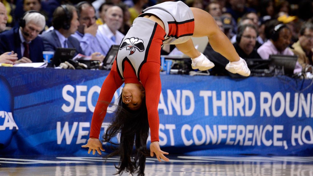 A University of Nevada Las Vegas Rebels cheerleader does a flip during game stoppage on March 21 in San Jose.