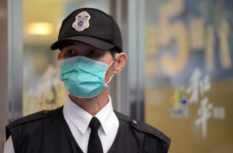 A masked security guard stands outside Taipei Hoping Hospital on April 6, where new isolation units have been set up to treat potential new avian influenza cases.