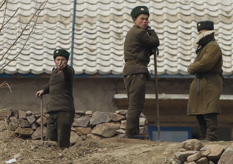 A North Korean soldier, near Sinuiju, gestures to stop photographers from taking photos in April 2013.