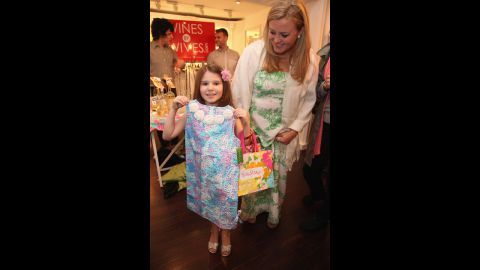 Charlotte Mendelson, left, shows off a new Lilly Pulitzer dress given to her by Camilla Webster during the 2012 Shop & Share.