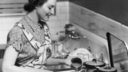 Woman prepares food, in 1950s-era U.S.