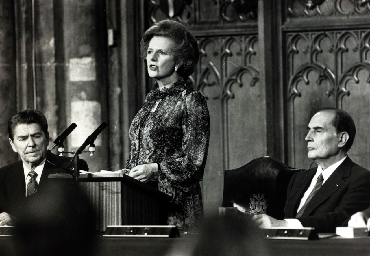 Thatcher reads a joint declaration in the Guildhall as Reagan and French President Francois Mitterand listen after a summit conference in London in May 1984.