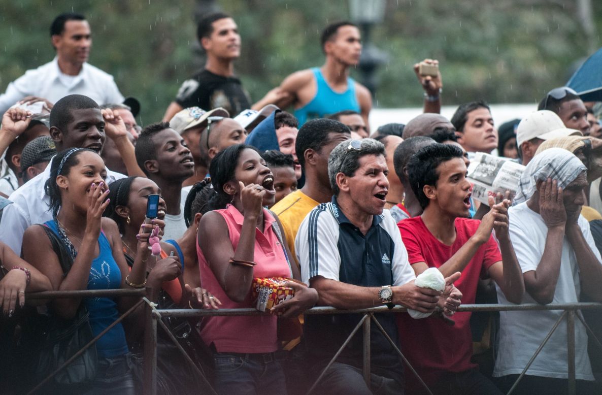 Cubans cheer as they wait to see Beyonce in front of the Saratoga Hotel in Havana on Friday. For decades, the U.S. government prohibited tourism to Cuba. In 2012, the Obama administration lifted some of the restrictions on travel to the country. Rules require a strict  itinerary for vacationers.