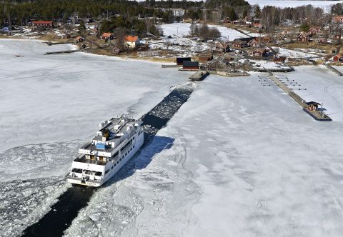 A passenger ship makes its way through a channel to the Swedish island of Husaro on Friday, April 5.