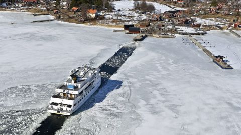 A passenger ship makes its way through a channel to the Swedish island of Husaro on Friday, April 5.