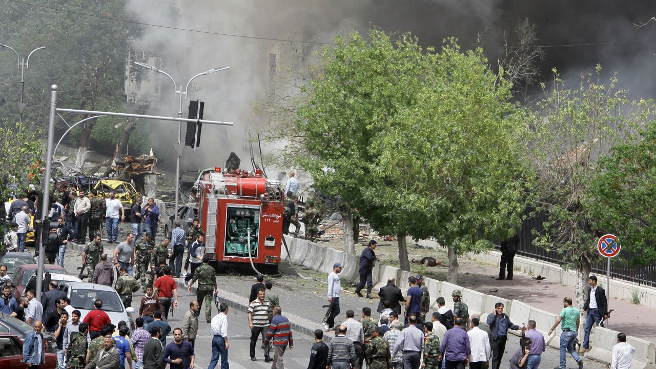 People inspect the scene of a deadly car bomb explosion which rocked central Damascus on Monday afternoon.