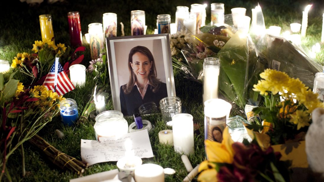A framed photograph of Giffords is seen among candles as a vigil is held outside a hospital in Tucson on January 8, 2011. Giffords was shot that day as she was meeting with constituents in front of a grocery store. Six people were killed. The gunman, Jared Lee Loughner, was sentenced to life in prison without parole in 2012.