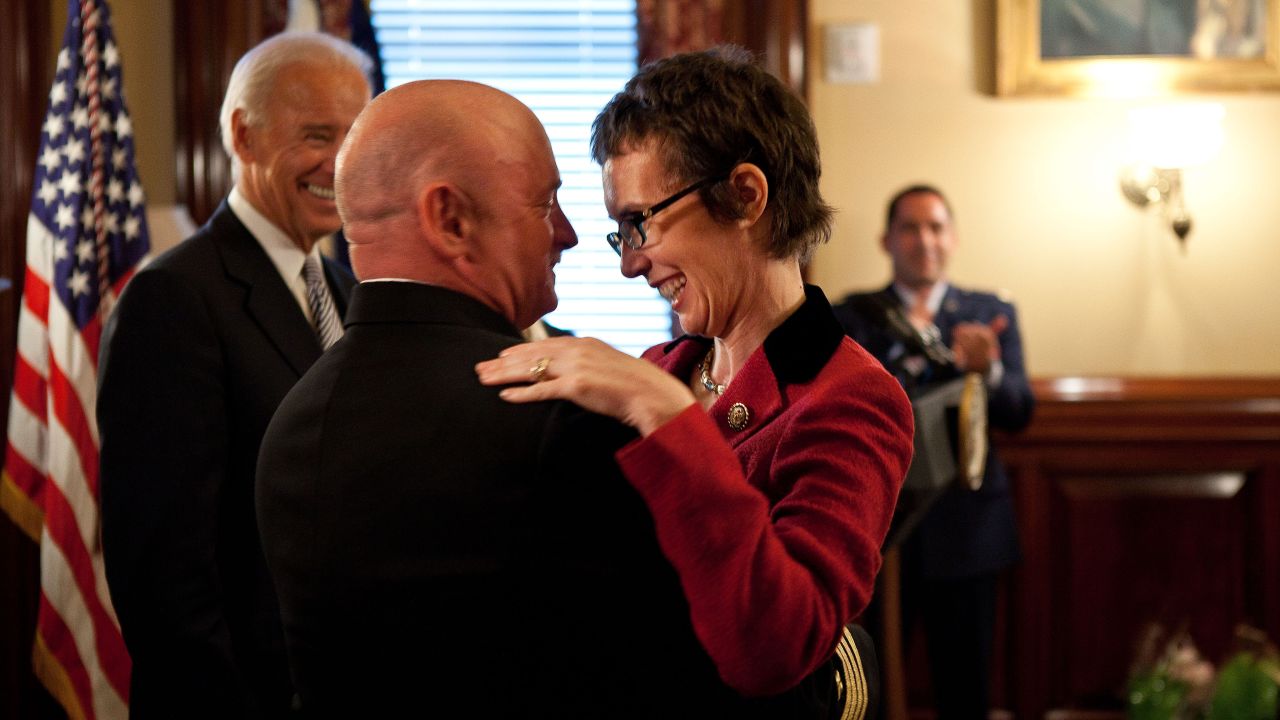 Kelly hugs his wife after receiving the Legion of Merit from Vice President Joe Biden during a retirement ceremony in Washington on October 6, 2011.