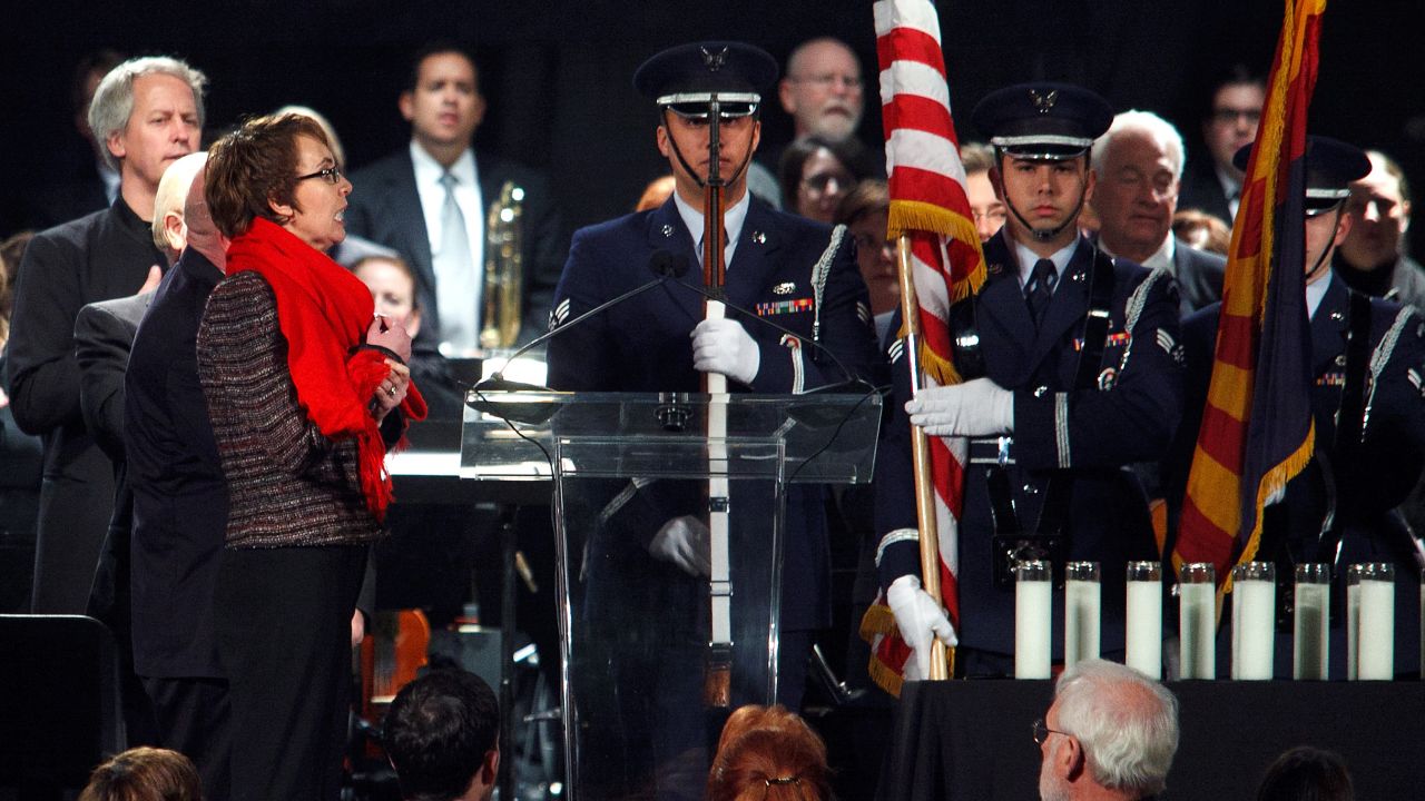 Giffords, at left, leads the Pledge of Allegiance during a vigil held at the University of Arizona Mall on the anniversary of the shooting in Tucson, Arizona, on January 8, 2012.