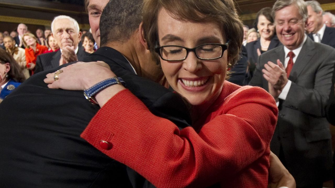 President Barack Obama embraces Giffords as members of Congress applaud before his State of the Union address in Washington on January 24, 2012.