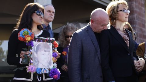 Giffords and Kelly attend a news conference on March 6, 2013 outside the Safeway grocery store in Tuscon. At the event they urged Congress to provide stricter gun control in the United States. At left, Roxanna Green holds a photo of her daughter, Christina Taylor Green, who was killed in the 2011 shooting.