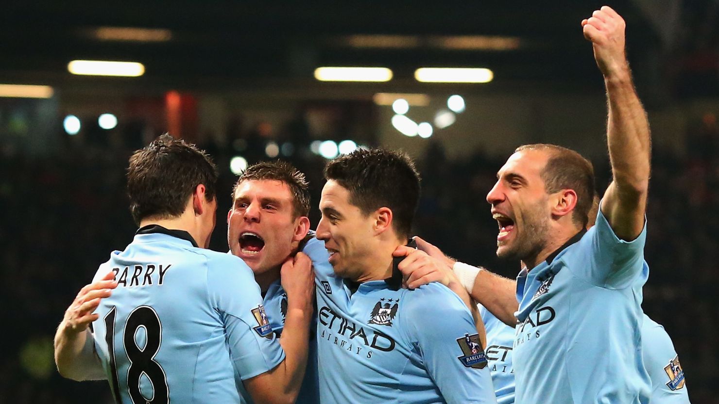 Manchester City players celebrate the opening goal by James Milner (second from left) as they stunned United at Old Trafford