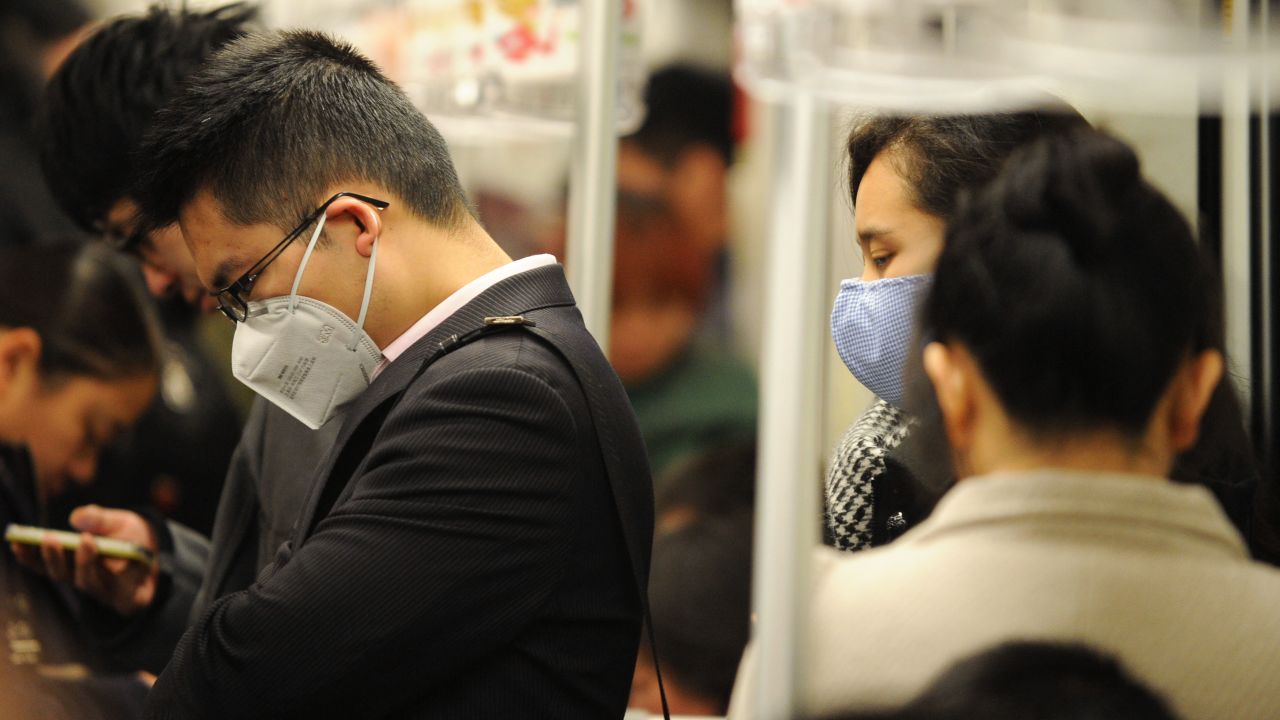People wear masks to protect themselves from the H7N9 virus, or bird flu, while riding the underground in Shanghai on Tuesday, April 9.