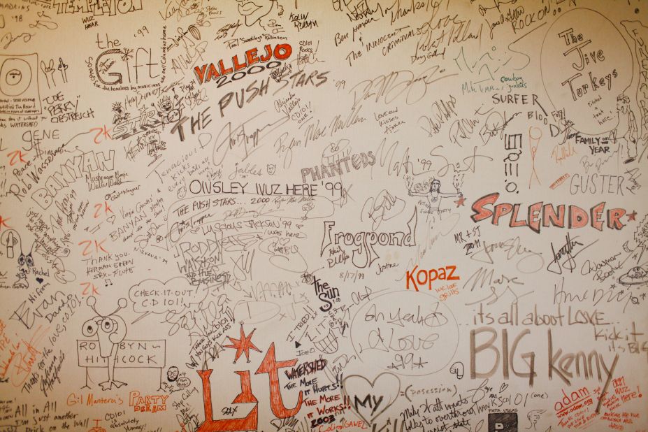 Bands that perform at the station leave their mark on walls around the Big Room.