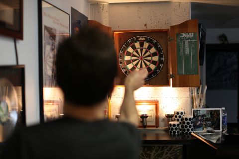 Staffers and interns play darts during some downtime on the weekend shift at CD102.5. 