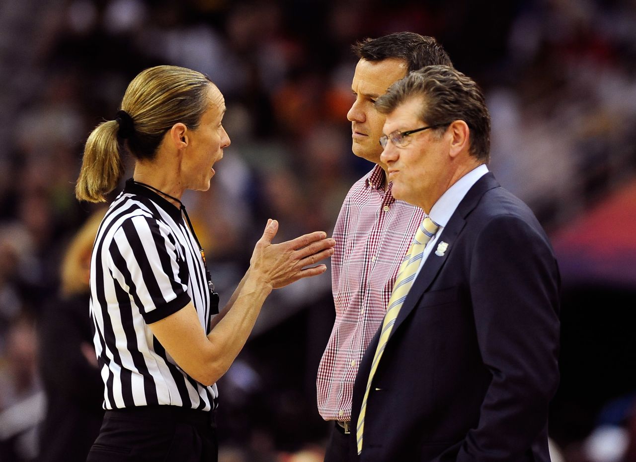 Head coach Geno Auriemma of the Connecticut Huskies and head coach Jeff Walz of the Louisville Cardinals speak to an official after a flagrant foul call during the game on April 9.