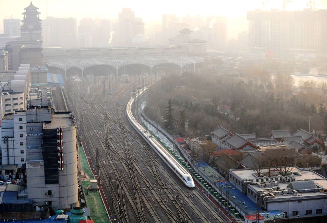 A train leaving Beijing West Rail Station. The world's longest high-speed rail line links Beijing and Guangzhou, China's southern hub 2,300 kilometers away.