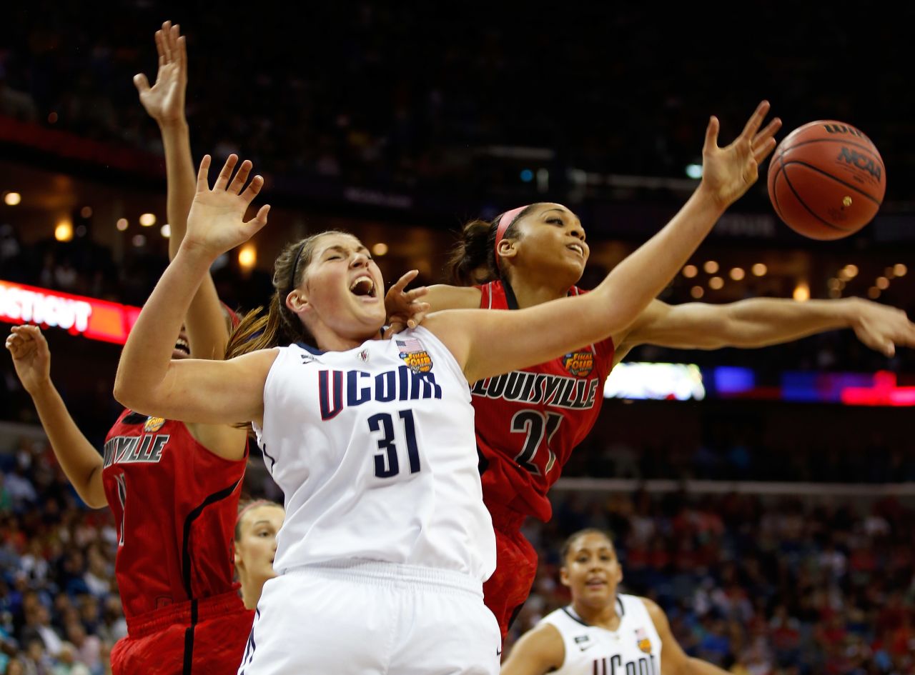Stefanie Dolson of the Connecticut Huskies and Bria Smith of the Louisville Cardinals go for a loose ball during the NCAA Women's Championship at New Orleans Arena on April 9.