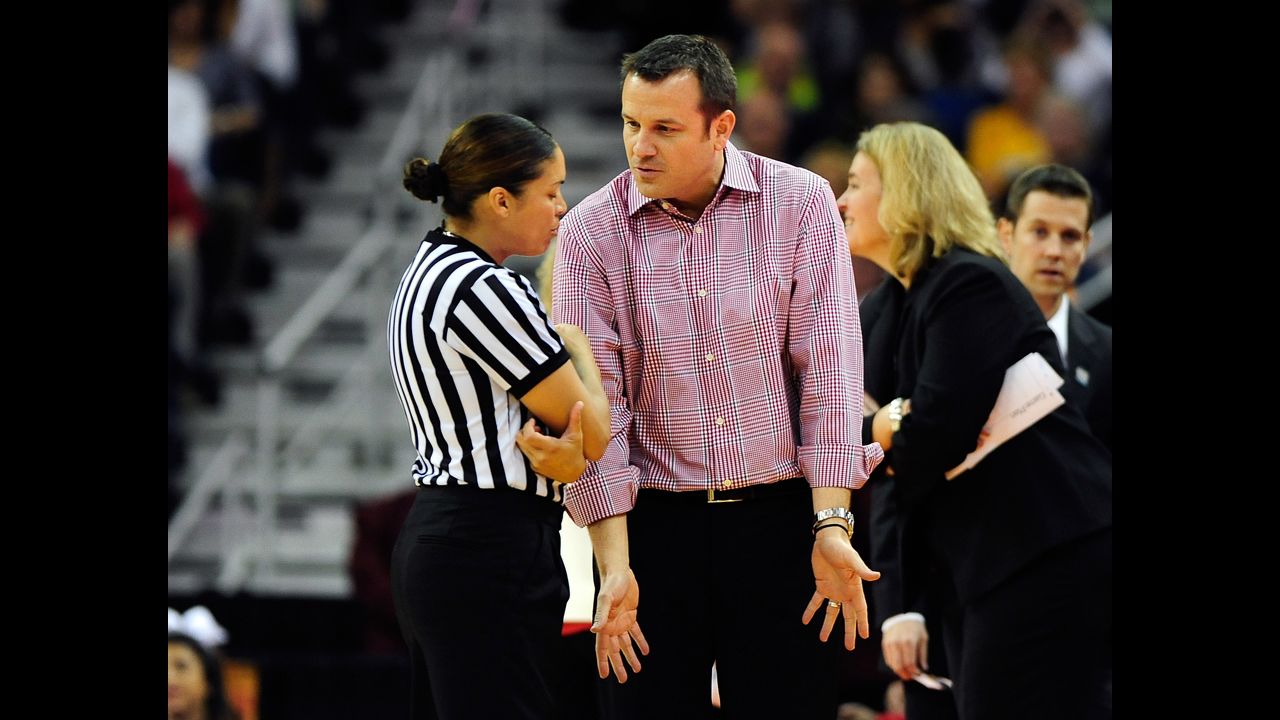 Head coach Jeff Walz of Louisville speaks to an official after a play against UCONN on April 9.