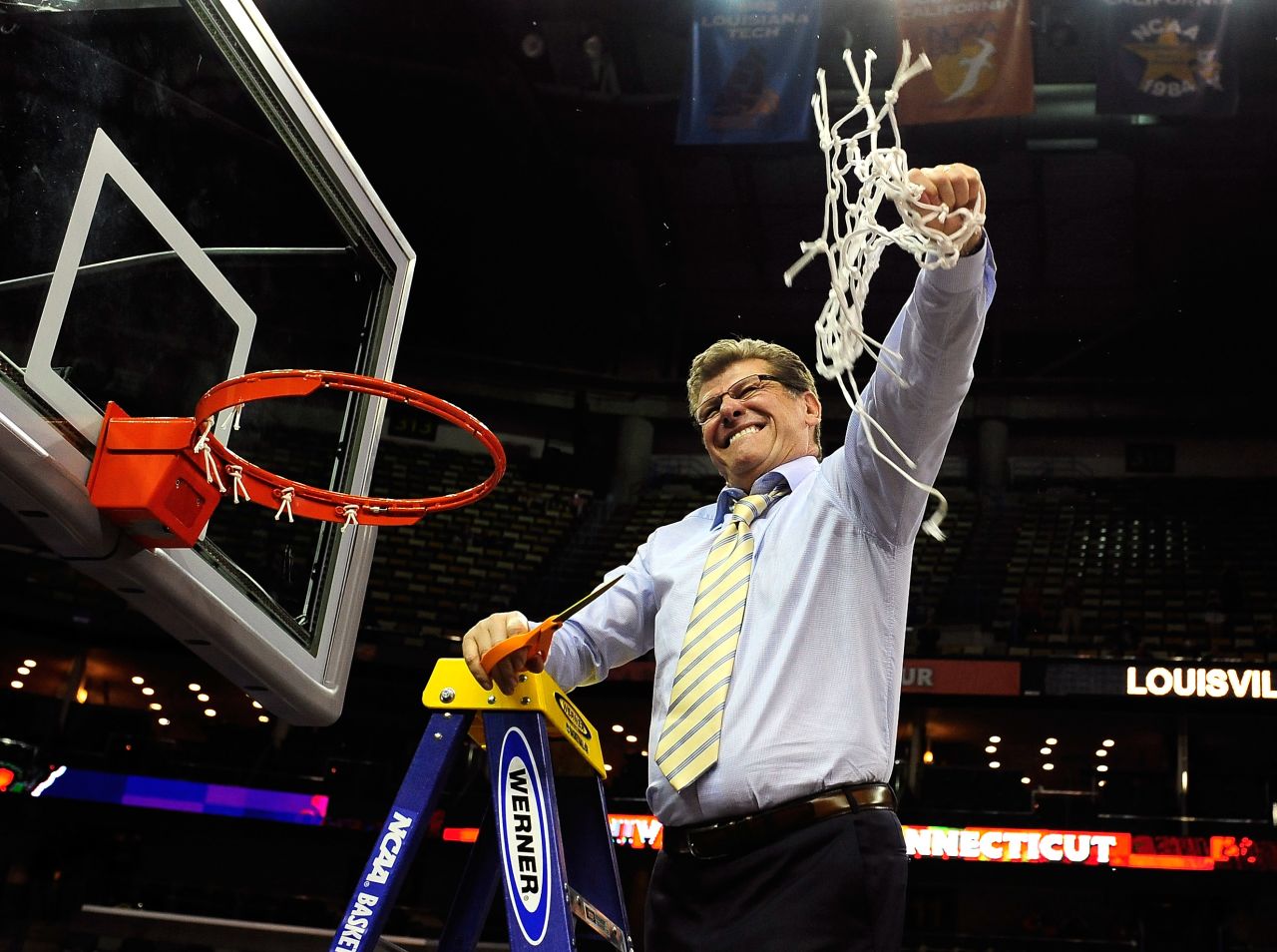 UCONN head coach Geno Auriemma cuts down the net after defeating the Louisville Cardinals on April 9.
