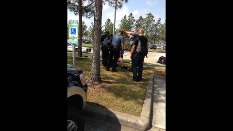 Maida posted this photo of officers restraining the suspect.