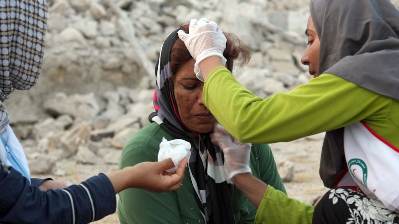 Aid workers give a woman medical treatment in Shanbeh on April 9.